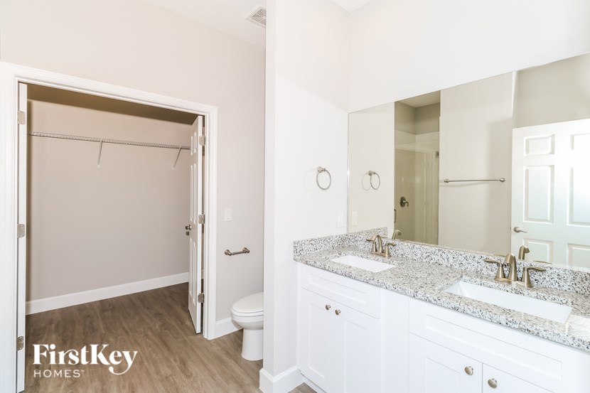 A bathroom with a white toilet and a white sink.