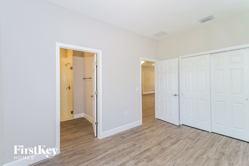 A room with a white door and a white wall.