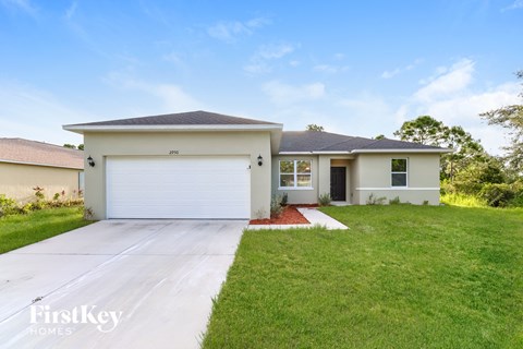A two-story house with a garage is for sale.