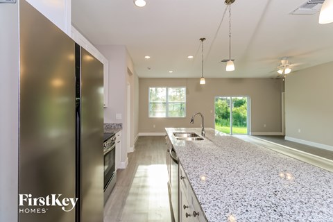 A kitchen with a FirstKey Homes sign on the fridge.