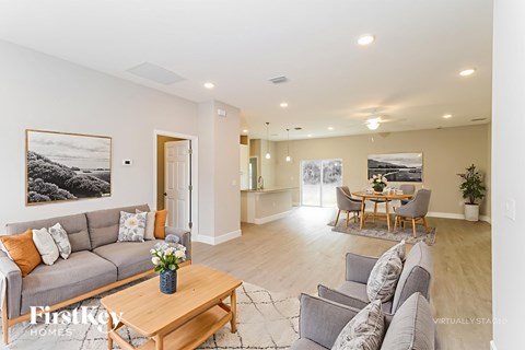 A living room with a grey couch and a wooden coffee table.
