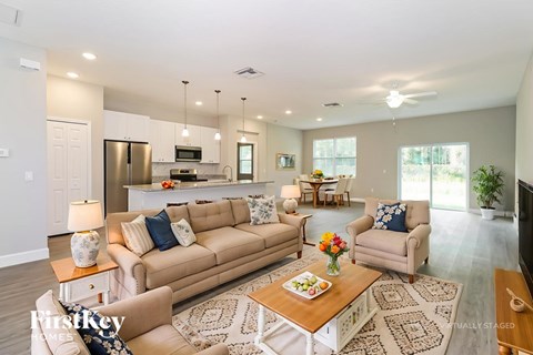 A living room with a couch, chairs, and a coffee table.