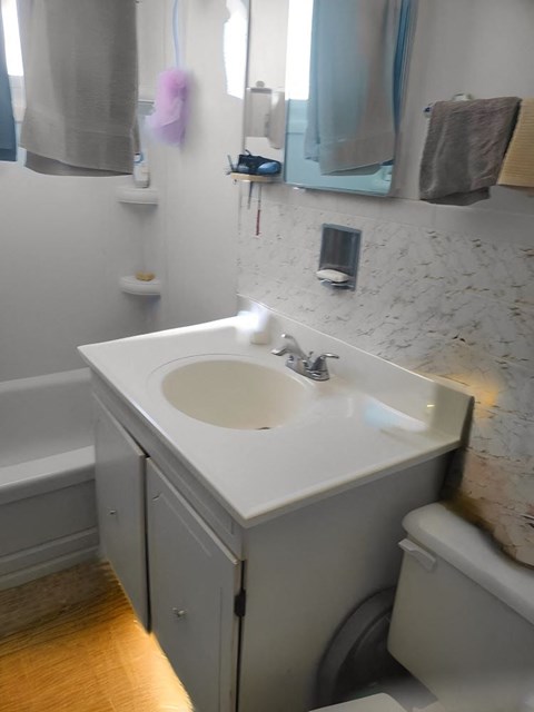 A white sink in a small bathroom.