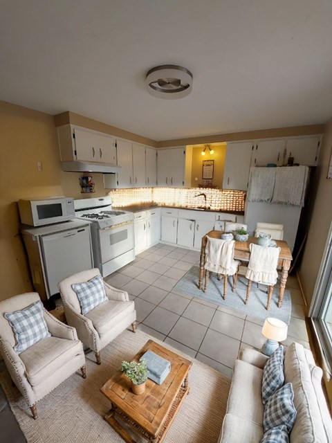 A kitchen with a table and chairs in the middle of the room.