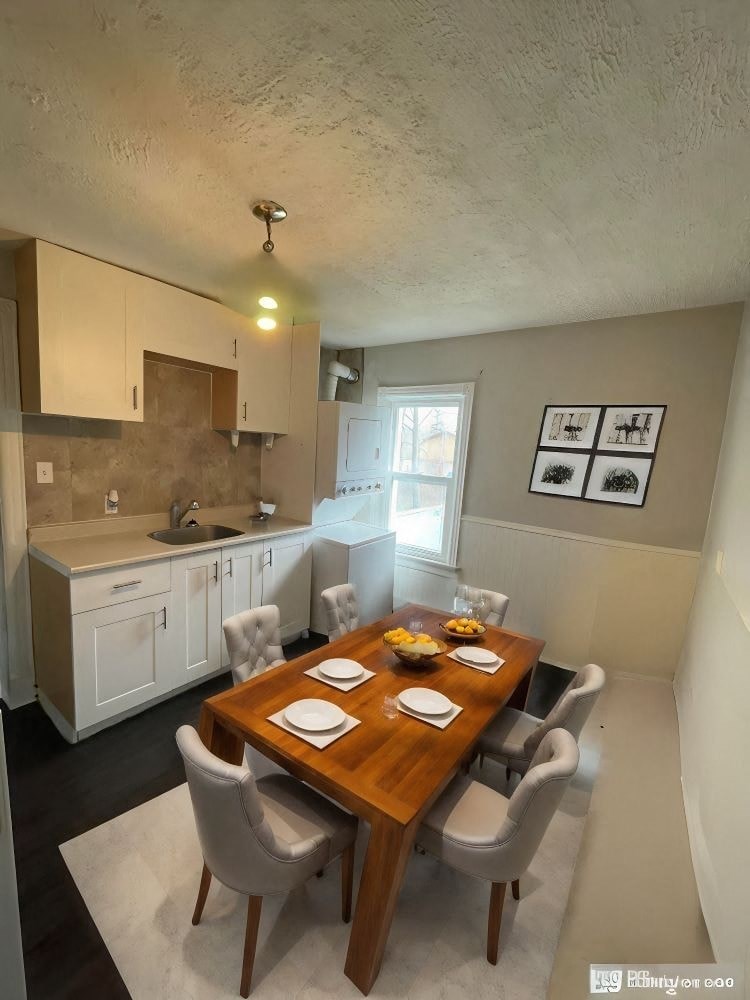 A dining room with a wooden table set for two.