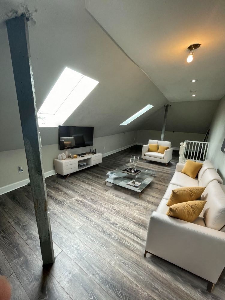 A living room with a white couch and a coffee table.