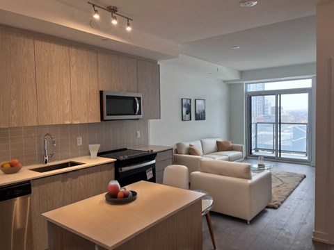 A modern kitchen with a dining table and chairs.