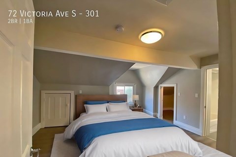 A bedroom with a bed and a window.