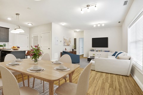 A dining room with a wooden table set for four.