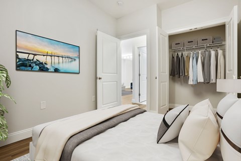 A bedroom with a large bed and a painting on the wall.