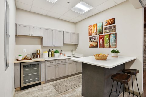 A kitchen with a white counter and a fridge.