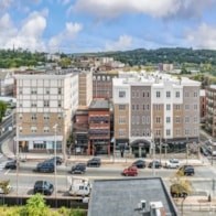 A city street with cars and buildings.