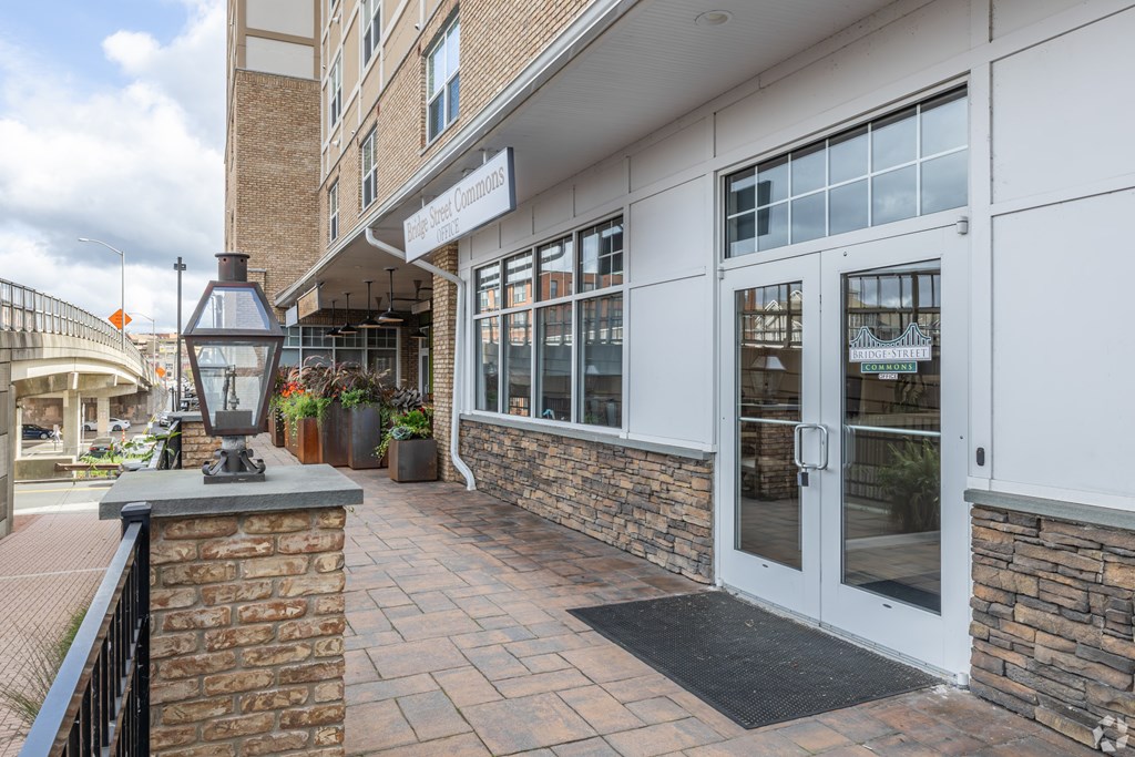 A building with a white facade and a glass door.