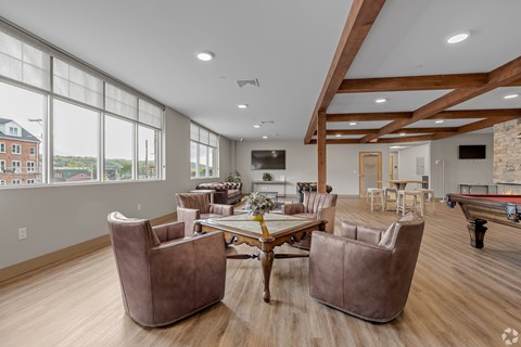 A large room with a long table and chairs.