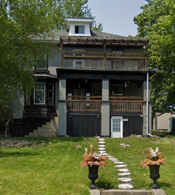 A house with a balcony and a white door.