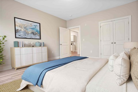 A bedroom with a large bed and a painting on the wall.