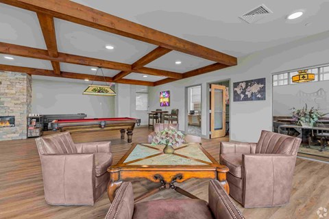A room with a pool table and a fireplace.