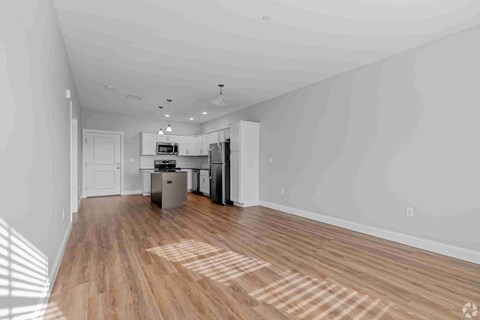 A kitchen with wooden floors and white walls.