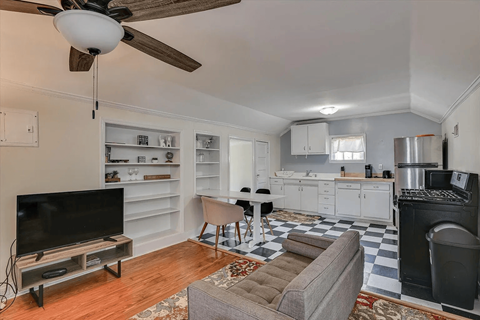 A living room with a television and a couch.