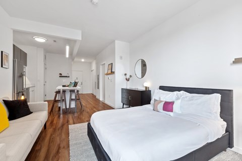 A bedroom with a large bed and a couch.