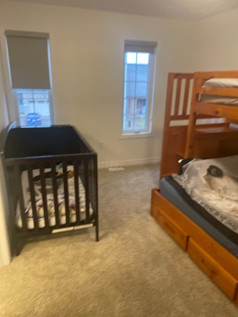 A baby's room with a crib and a bunk bed.