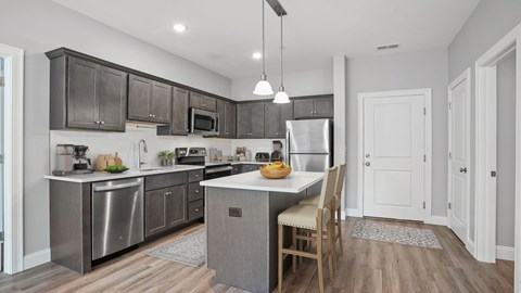 A modern kitchen with a dining table and chairs.