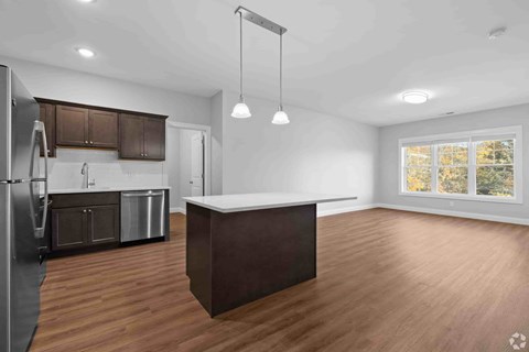 A kitchen with wooden floors and a large island.