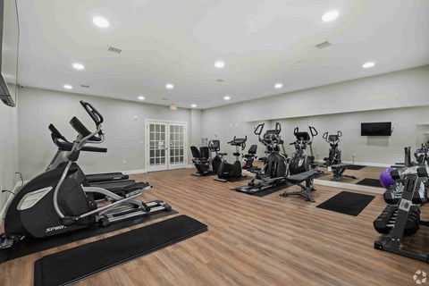 A spacious gym with a variety of exercise equipment.