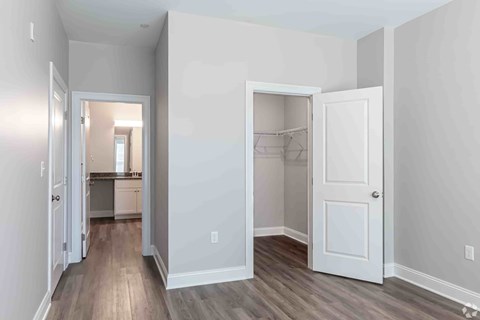 A white door is open to a kitchen.