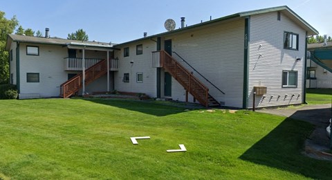 A house with a green lawn in front.