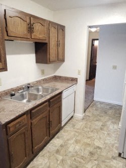 A kitchen with brown cabinets and a sink.