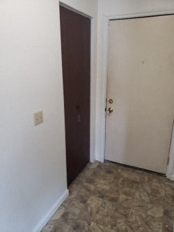 A room with a brown door and a white door.