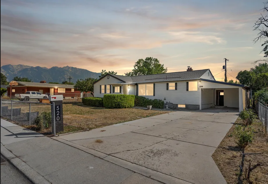 A house numbered 520 is shown with a driveway and a mountain in the background.