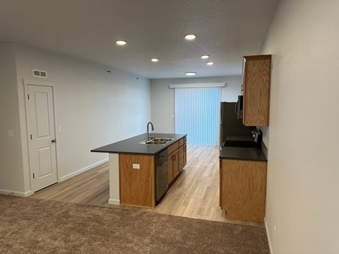 A kitchen with a sink and a refrigerator.
