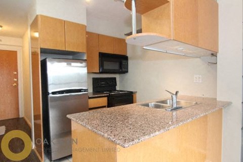 A kitchen with granite countertops and stainless steel appliances.