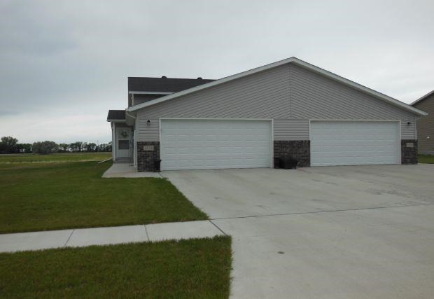 a white house with a driveway in front of it