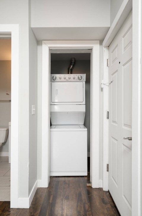 A white oven and dishwasher are built into a wall in a kitchen.