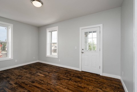 A room with a wooden floor and white walls.
