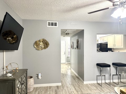 A room with a ceiling fan and a mirror on the wall.