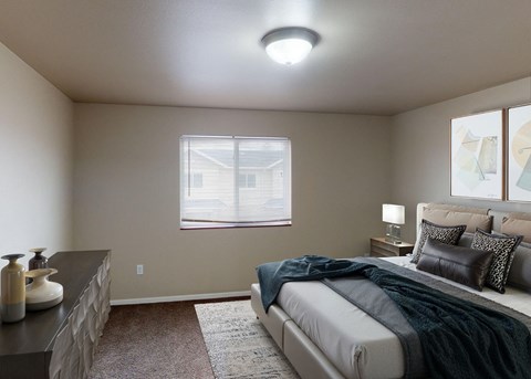 A bedroom with a bed, nightstand, and window.