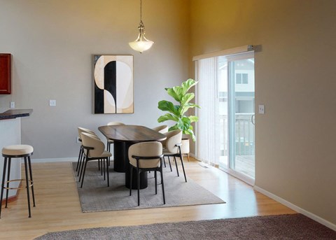 A modern dining room with a round table and chairs.