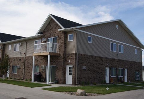 a brick house with a balcony on the side