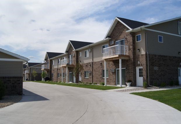 an empty street in front of a row of houses
