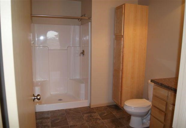 a bathroom with a toilet and a shower
