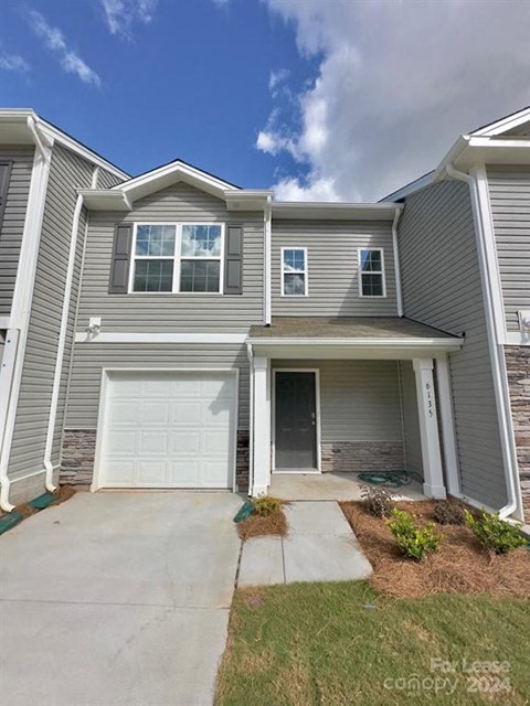 A two-story house with a garage is for lease.