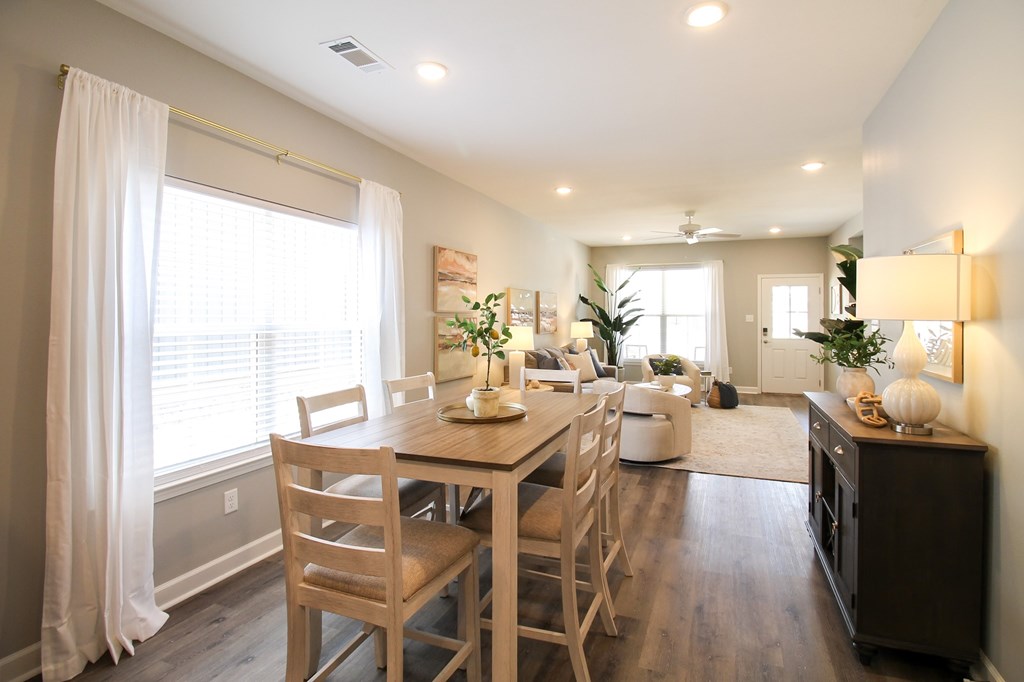 A dining room with a table and chairs.