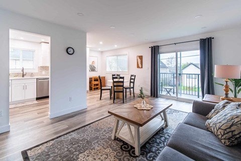 A living room with a grey couch and a wooden coffee table.