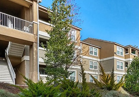 A multi-story residential building with a balcony on the second floor.