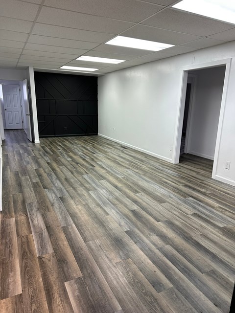 A room with a wooden floor and white walls.