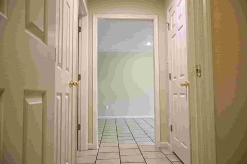 A hallway with a door at the end.